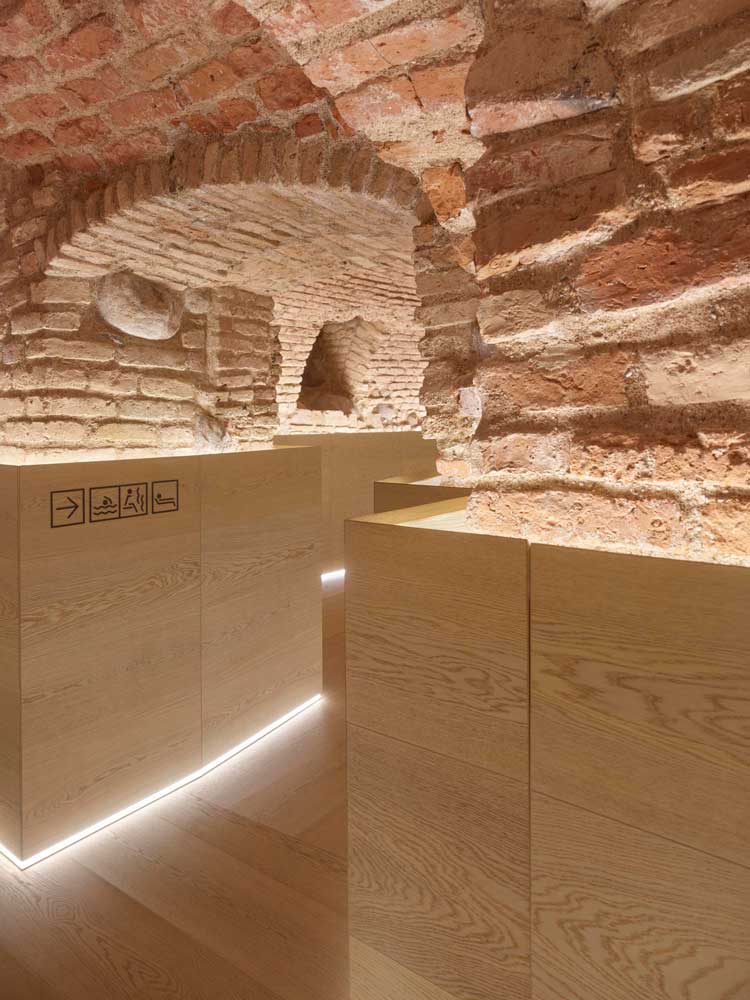 Boksto Spa. The medieval vaults have been repaired, their walls restored, and protected by this wooden panelling installed along this corridor to hide the services and lighting. Boksto 6, Vilnius, Lithuania, 2020.