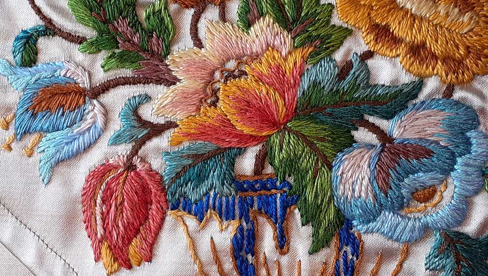Gold table runner embroidered with flowers from Hill of Tarvit, Fife (detail), Satin embroidered with coloured silk threads, c1900–20. Image © The National Trust for Scotland.