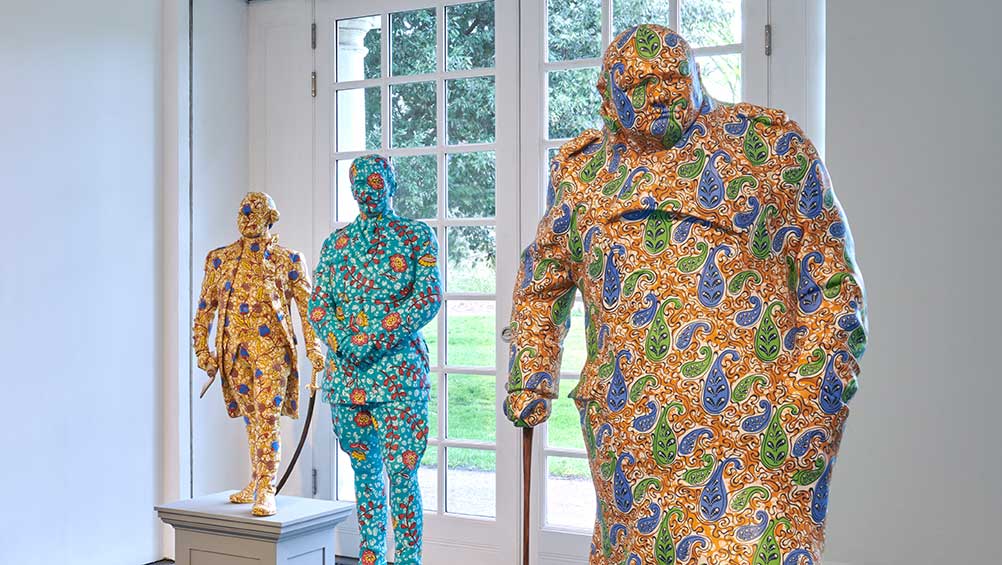 Decolonised Structures (Sir Winston Churchill in foreground), Installation view, Yinka Shonibare CBE: Suspended States, Serpentine South, 2024. © Yinka Shonibare CBE 2024. Photo: © Jo Underhill. Courtesy Yinka Shonibare CBE and Serpentine.