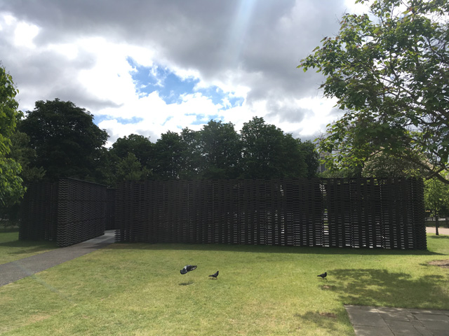 Frida Escobedo’s Serpentine Pavilion 2018 disappearing into the landscape. Photograph: Veronica Simpson.