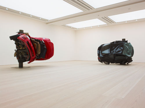 Dirk Skreber. Left: Untitled (Crash 1), 2009. Red Mitsubishi Eclipse Spider 2001, 292.1 x 322.6 x 236.2 cm. Right: Untitled (Crash 2), 2009. Black Hyundai Tiburon 2001, 231.1 x 315 x 259cm. Courtesy the Saatchi Gallery, London. © Dirk Skreber, 2011. Photo © Stephen White.
