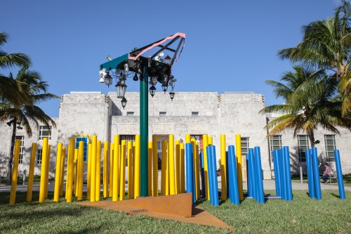 Jessica Stockholder. Installation view: Angled Tangle. Art Basel Miami Beach, 2014. Steel, aluminium, auto paint, light fixtures, plastic bollards, gravel. Site-specific installation. Photograph: Joseph Rynkiewicz. Courtesy of the artist, Kavi Gupta Gallery, and Mitchell-Innes & Nash, NY.