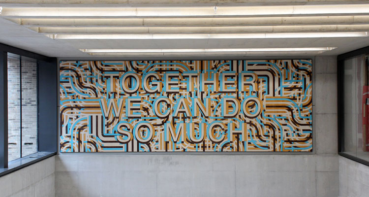 Mark Titchner. Together we can do so much, 2019. Veneered and stained Valcromat. Installed Zayed Centre for Research into Rare Disease in Children, Great Ormond Street Hospital.