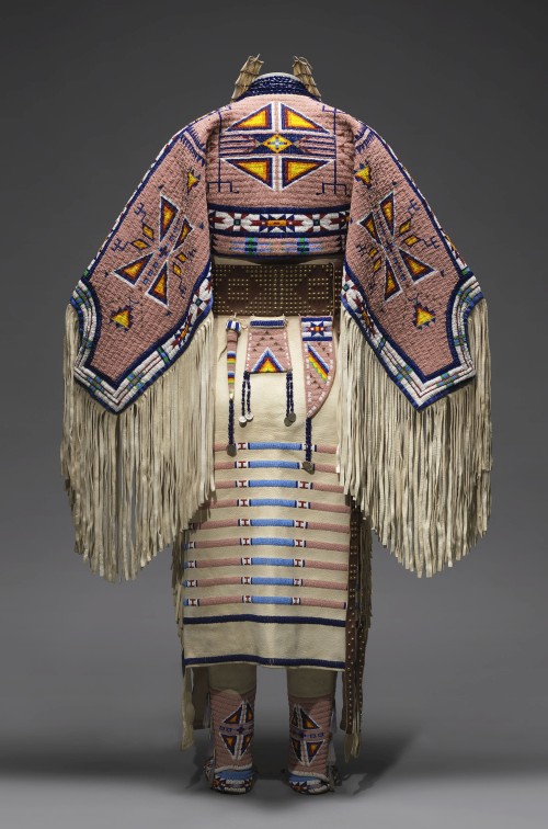 Woman’s Dress and Accessories, 2005. Jodi Gillette (1959-), Hunkpapa Lakota (Teton Sioux), North Dakota. Native tanned and commercial leather, glass and metal beads, cotton cloth, silk, dentalium shell, metal cones, horsehair, plastic, hair pipes, brass bells, porcupine quills, brass tacks, brass and metal studs, silver cones. 54 × 60 in (137.2 × 152.4 cm). United States, Courtesy of Jodi Gillette. Photograph: Joshua Ferdinand, courtesy of Jodi Gillette. (Cat.134).